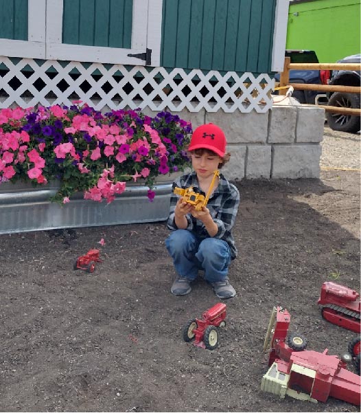 a boy playing with toy trucks