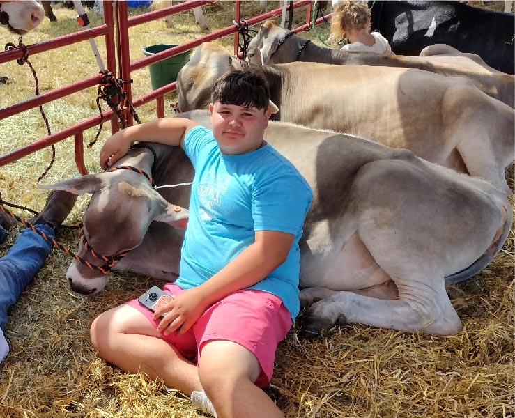 a young exhibitor with his cow