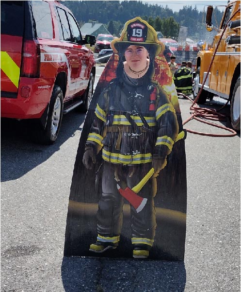 a fair goer in a fireman cutout